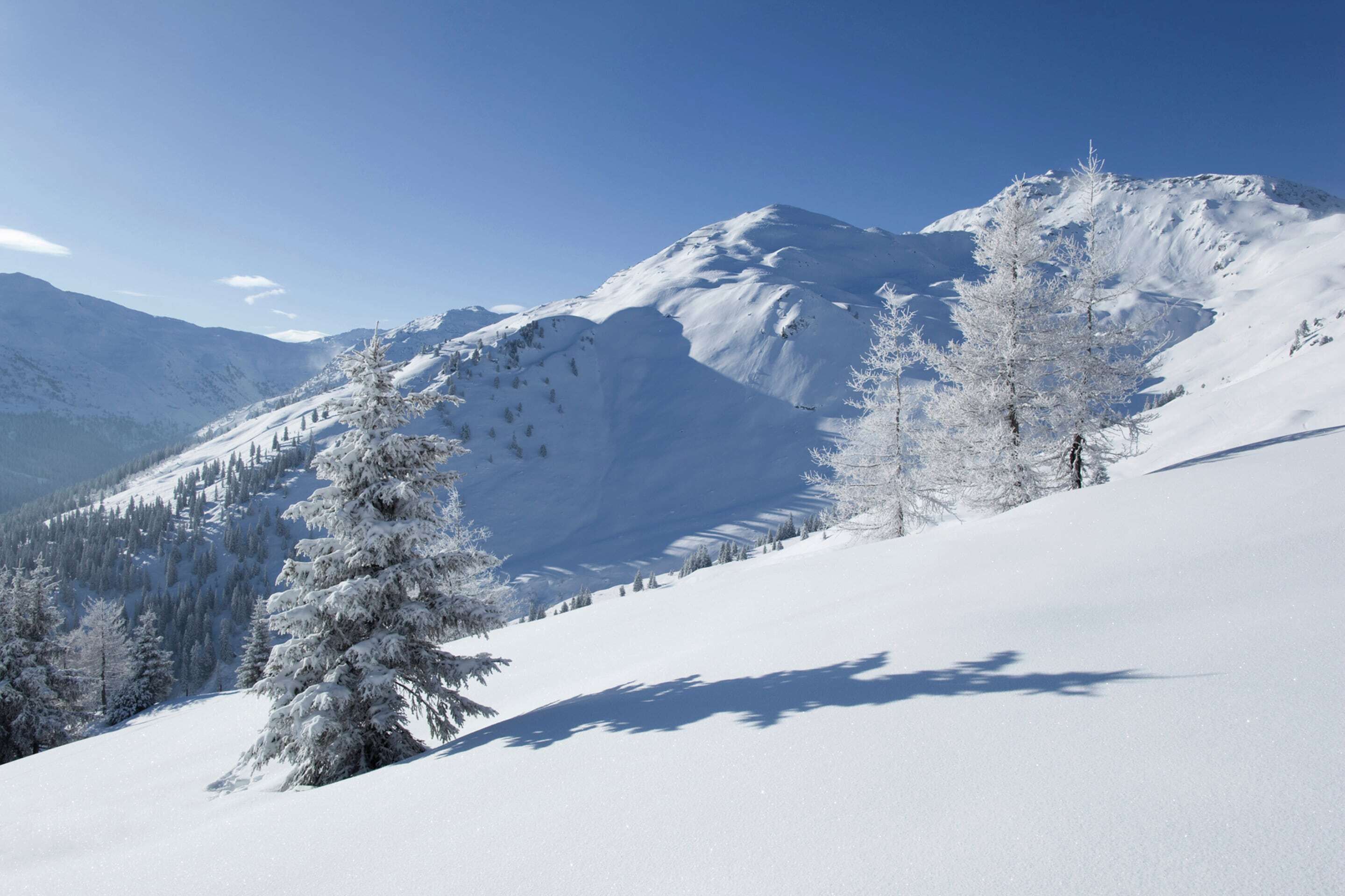 A snow-covered mountain landscape with a clear sky.