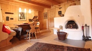 A cozy wooden interior with a fireplace, wooden furniture, and a rug. - Chalet in St Johann on Ski Slopes (Sankt Johann in Tirol)