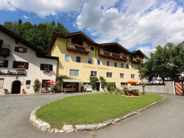 A traditional European building with a sign reading "Pension Dorfpartier".