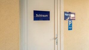 A door labeled "Schiraum" with a "Landhaus Heidi" sign and a "P Privat" parking sign on the wall. - Luxury Holiday Home in Brixen im Thale Near Ski Area (Brixen im Thale)