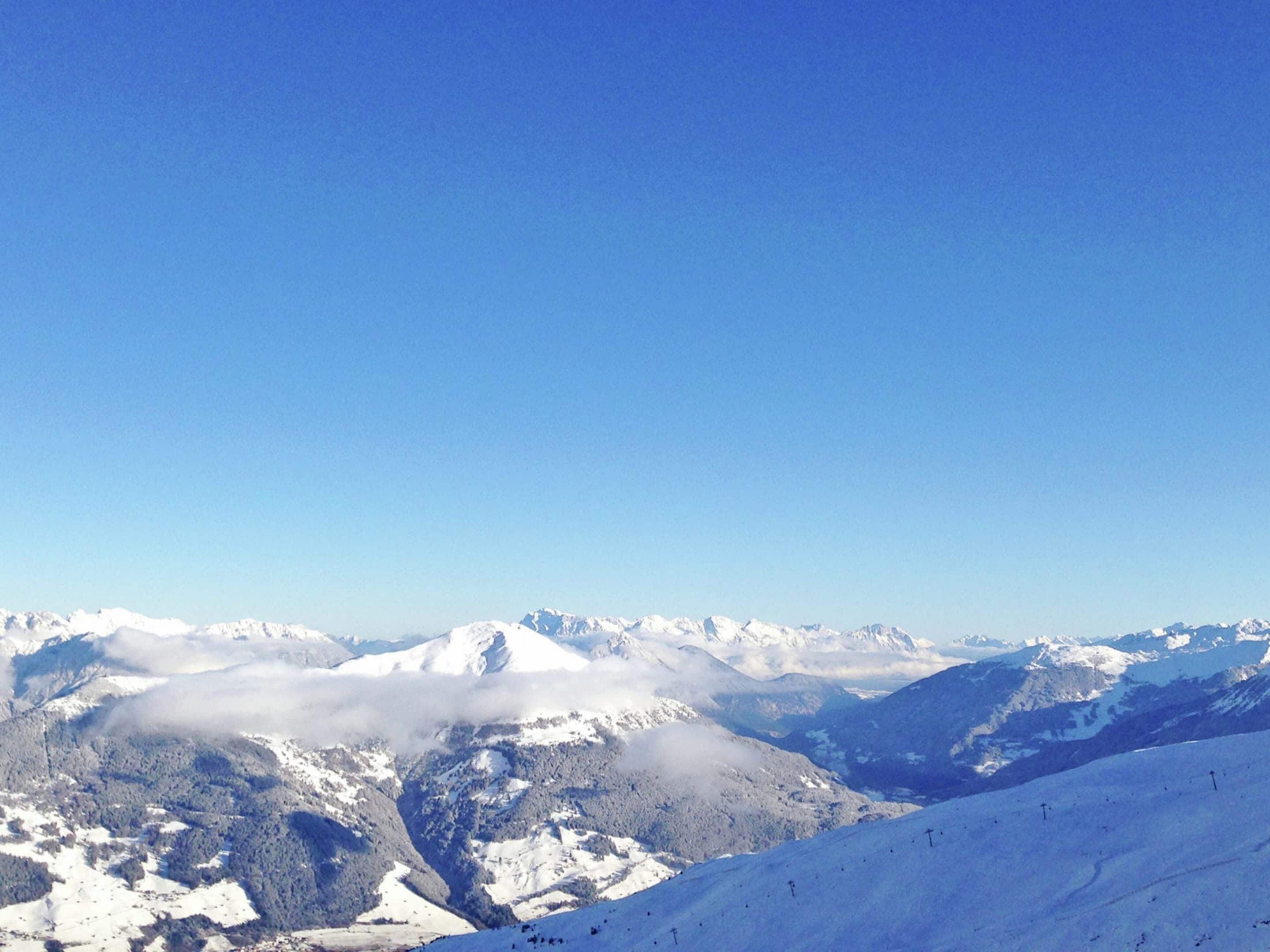 A snow-covered mountain landscape with clear skies.
