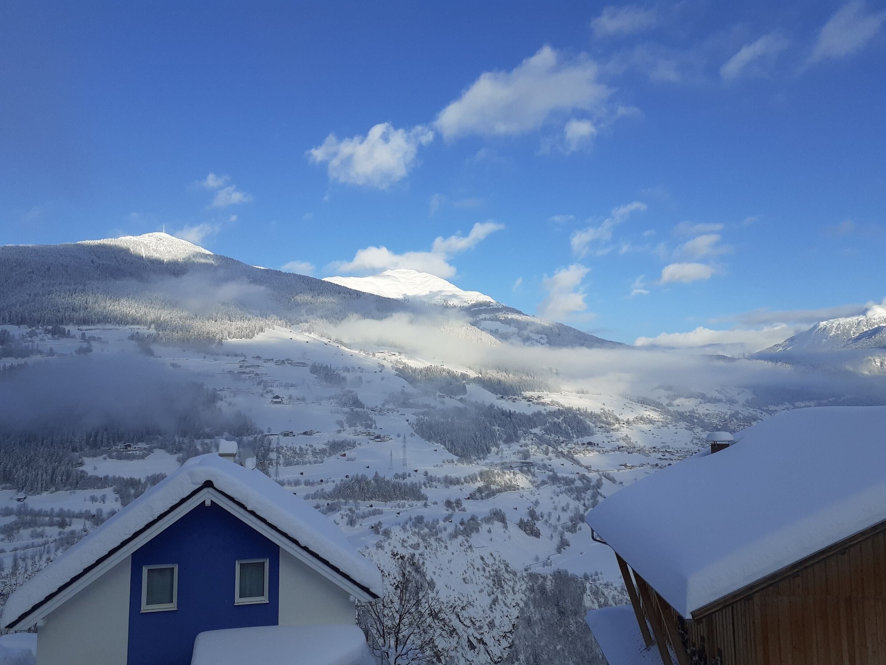 A snow-covered mountain landscape with a clear sky.