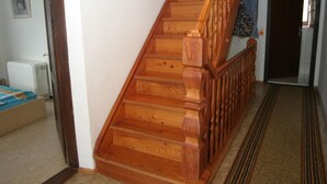 A wooden staircase with a handrail, leading to an upper floor. - Scenic Holiday Home in Deutsch Griffen near Hochrindl (Deutsch-Griffen)