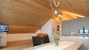A modern kitchen with grey cabinets, a stainless steel oven, and a wooden ceiling. - Cozy Apartment in Schruns Vorarlberg near Ski Area Montafon (Schruns)