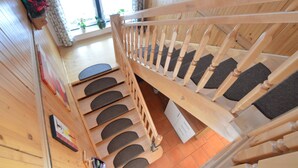 A wooden staircase with a handrail, leading to a lower level. - Chalet in Einach Near Ski Slopes (Stadl-Predlitz)