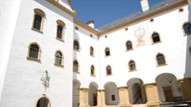 A white building with multiple windows and arches, likely a historical or institutional building. - Chalet in Einach Near Ski Slopes (Stadl-Predlitz)
