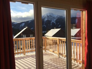 A balcony with a wooden railing overlooking a snowy mountain landscape. - Nice Chalet in Hohentauern / Styria With Sauna (Hohentauern)
