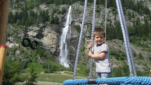 A child on a swing with a waterfall in the background. - Peaceful Cottage near Ski Area in Gmünd (Gmuend in Kaernten)