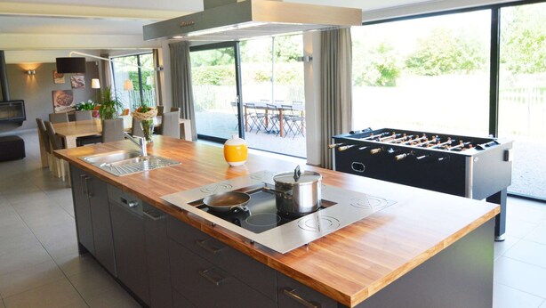 A modern kitchen with a central island, a built-in stove, and a foosball table. - Family Villa, Profondeville (Profondeville)
