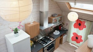 A modern kitchen with a gas stove, wooden cabinets, and a skylight. - Beautiful Apartment in Spa Belgium with Hot Tub (Spa)