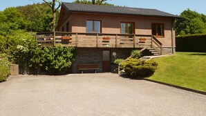 A two-story brick building with a balcony, a front door, and a small front yard. - Retreat in Malmedy Hills (Malmedy)