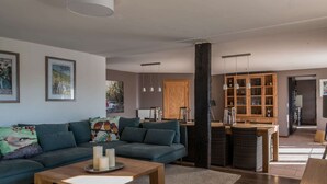 A modern living room with a sofa, coffee table, and a wooden cabinet. - Holiday Home in Cetturu With Sauna (Houffalize)