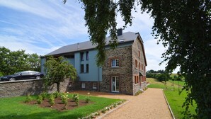 A two-story house with a stone facade and a blue exterior. - Holiday Home in Cetturu With Sauna (Houffalize)