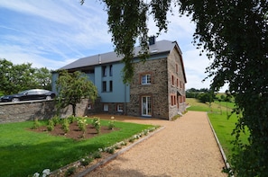 A two-story house with a stone facade and a blue exterior. - Holiday Home in Cetturu With Sauna (Houffalize)