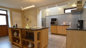 Una cocina moderna con una isla central, armarios de madera y electrodomésticos integrados.