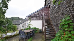 A rustic stone building with a wooden staircase leading to a second floor. - Lovely Holiday Home In Frahan With Terrace (Bouillon)