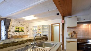 A kitchen with granite countertops, stainless steel sink, and wooden cabinets. - Lovely Holiday Home In Frahan With Terrace (Bouillon)