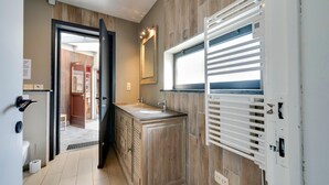 A modern bathroom with a wooden vanity, a large mirror, and a window with blinds. - Splendid Villa in Middelkerke with Sauna, Hot Tub, Terrace (Middelkerke)