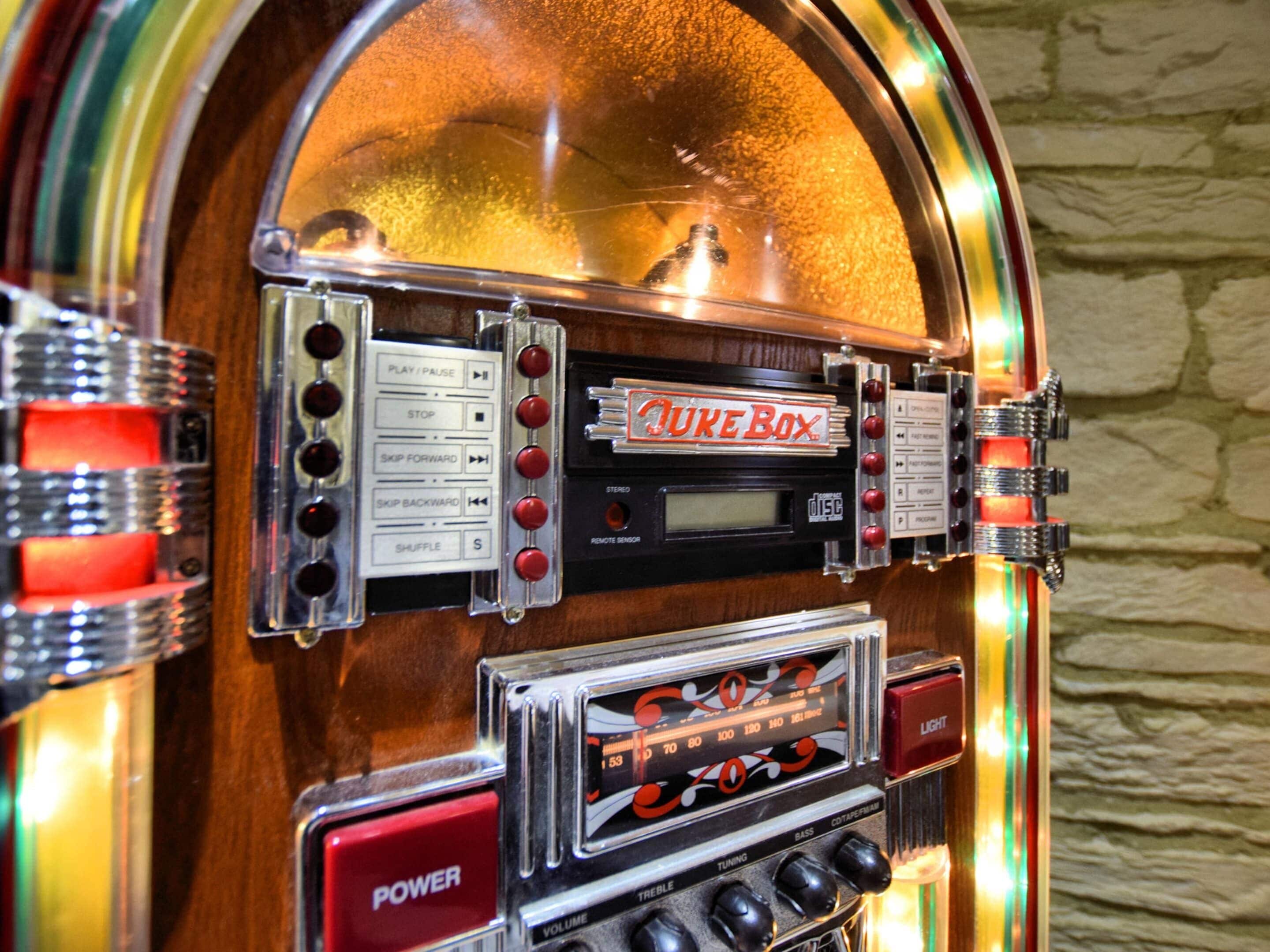 A jukebox with a 'Juke Box' sign, control buttons, a display screen, and volume controls.