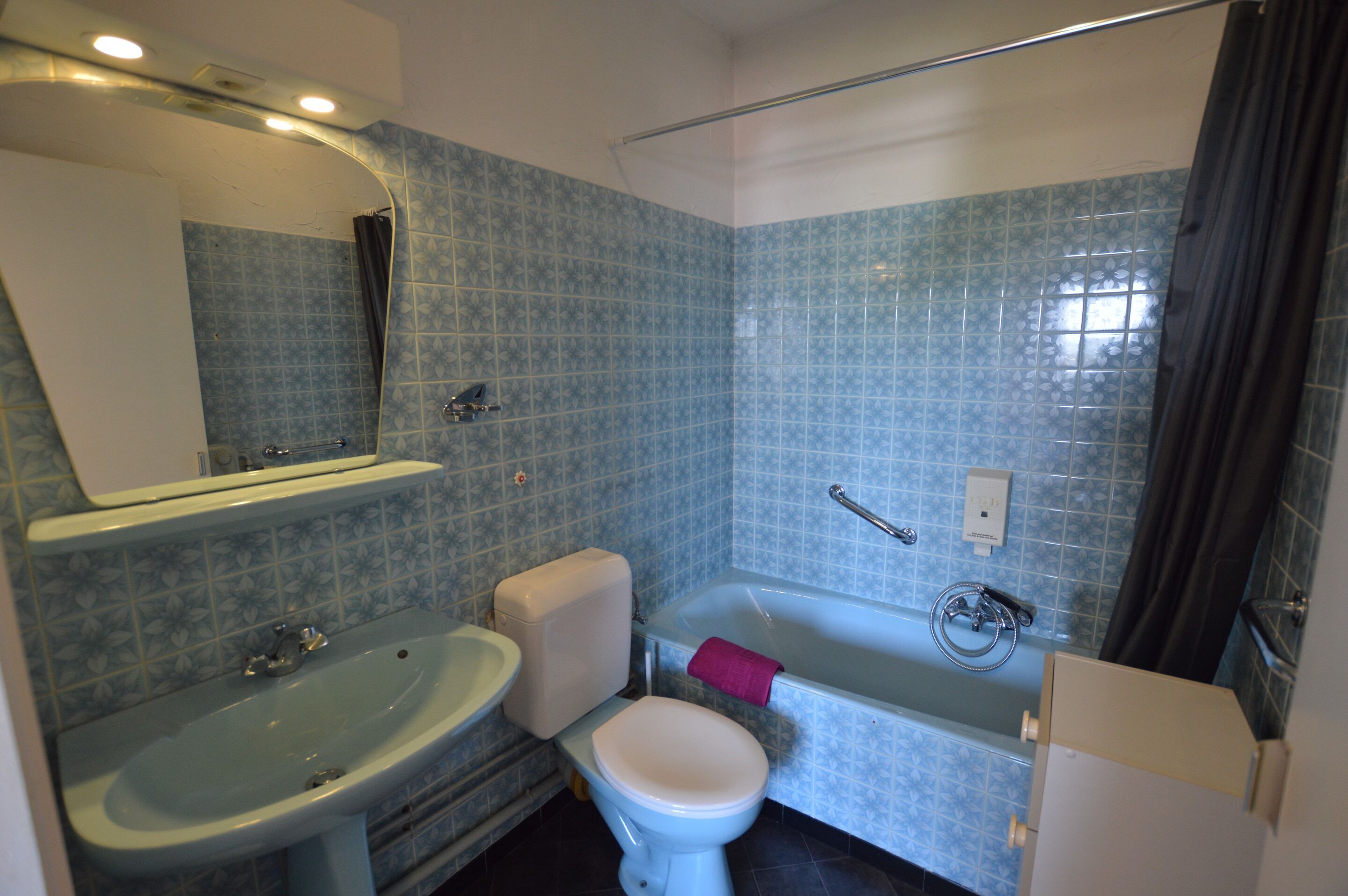 A bathroom with a sink, toilet, and bathtub.