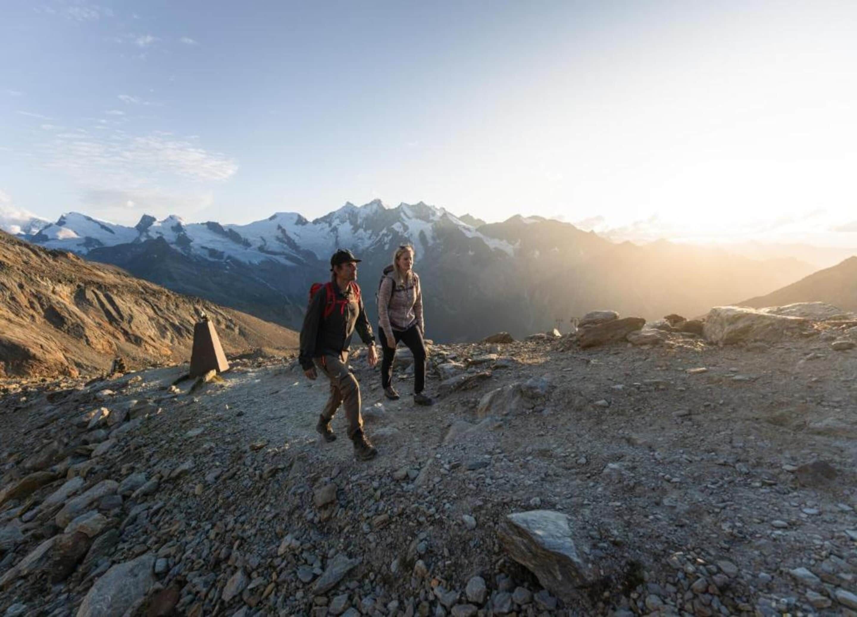 A rocky mountain path with hikers.