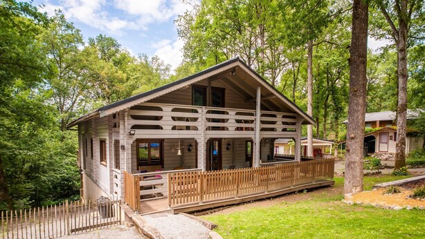 A wooden cabin with a balcony, surrounded by trees. - Chalet With Sauna Near Durbuy (Durbuy)