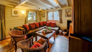 A cozy living room with a sofa, chairs, a coffee table, and a fireplace. - Chalet With Sauna Near Durbuy (Durbuy)