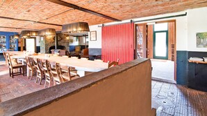 A spacious dining area with brick ceiling, wooden tables, and chairs. - Holiday Home in Sourbrodt With Pool & Sauna (Waimes)