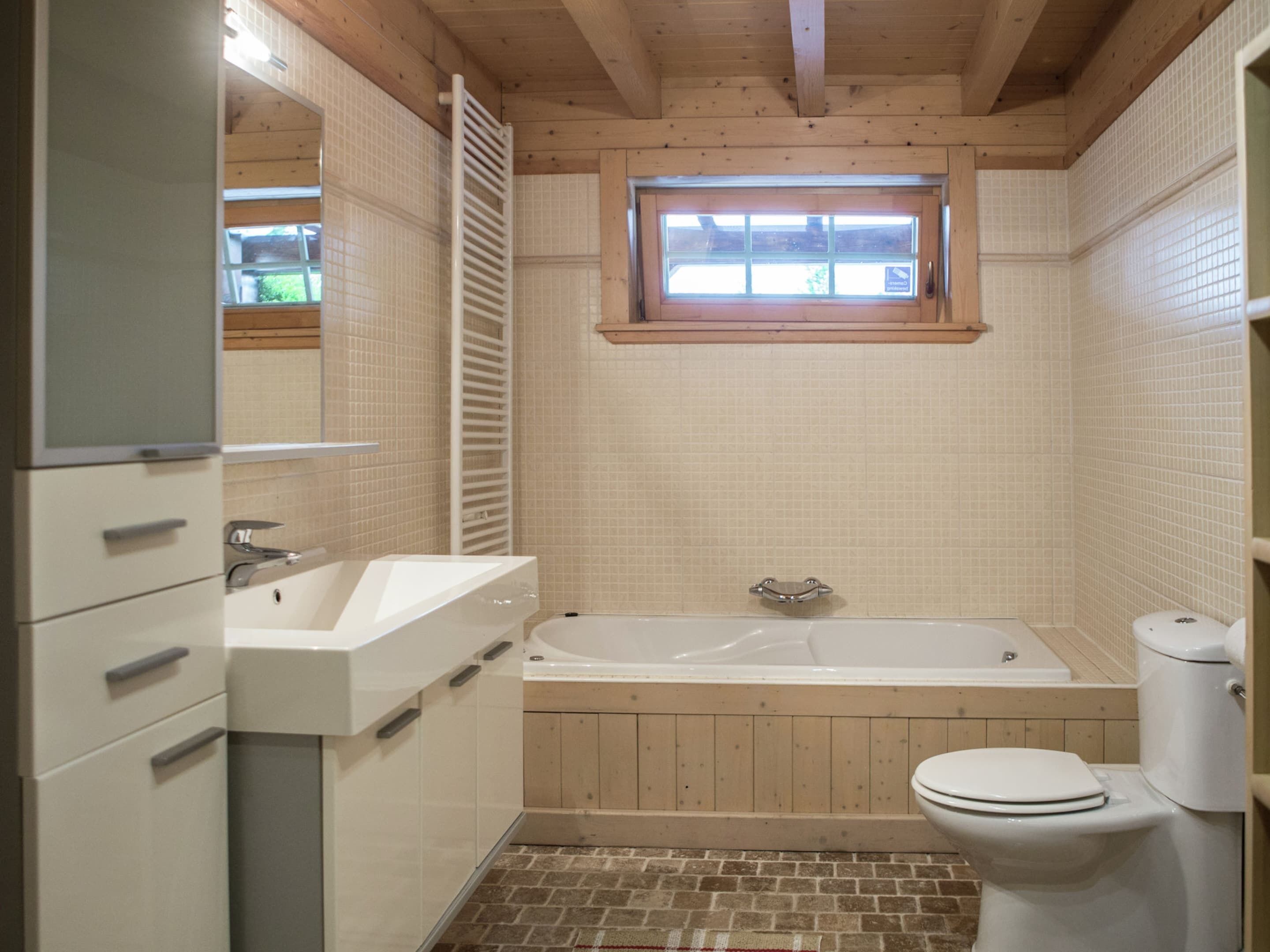 A bathroom with a bathtub, toilet, and sink.