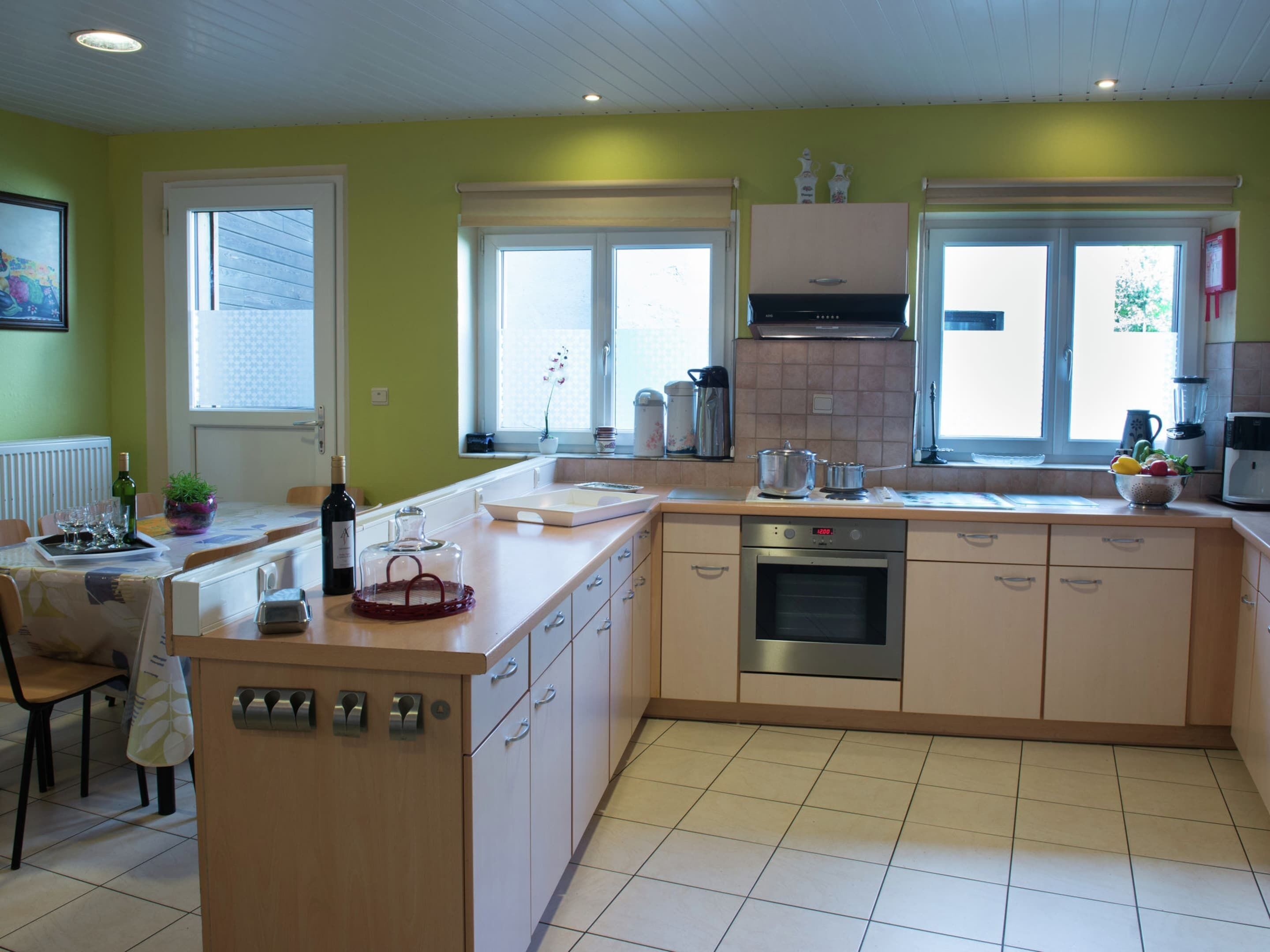 A modern kitchen with a central island, built-in oven, and ample counter space.