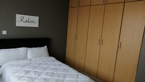 A bedroom with a bed, a wardrobe, and a sign that says "Relax". - Yurana Resort Kenya (Kitengela)