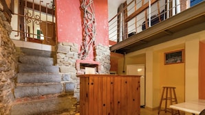 A rustic interior with a stone staircase, wooden paneling, and a high ceiling. - Glorious Holiday Home in Wéris with Hot Tub (Durbuy)