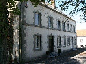 A two-story building with a symmetrical facade, multiple windows, and a central entrance. - Countryside Escape for 9 (Beauraing)