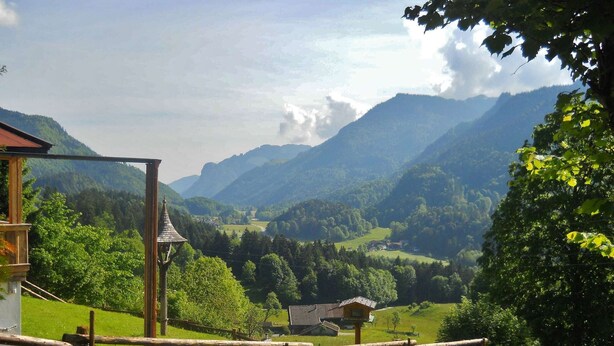 A rural landscape with a wooden fence, a small building, and a mountain backdrop. - Chalet With Terrace in Niederndorf/kufstein (Niederndorferberg)