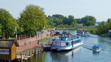 A river with boats docked at a pier.