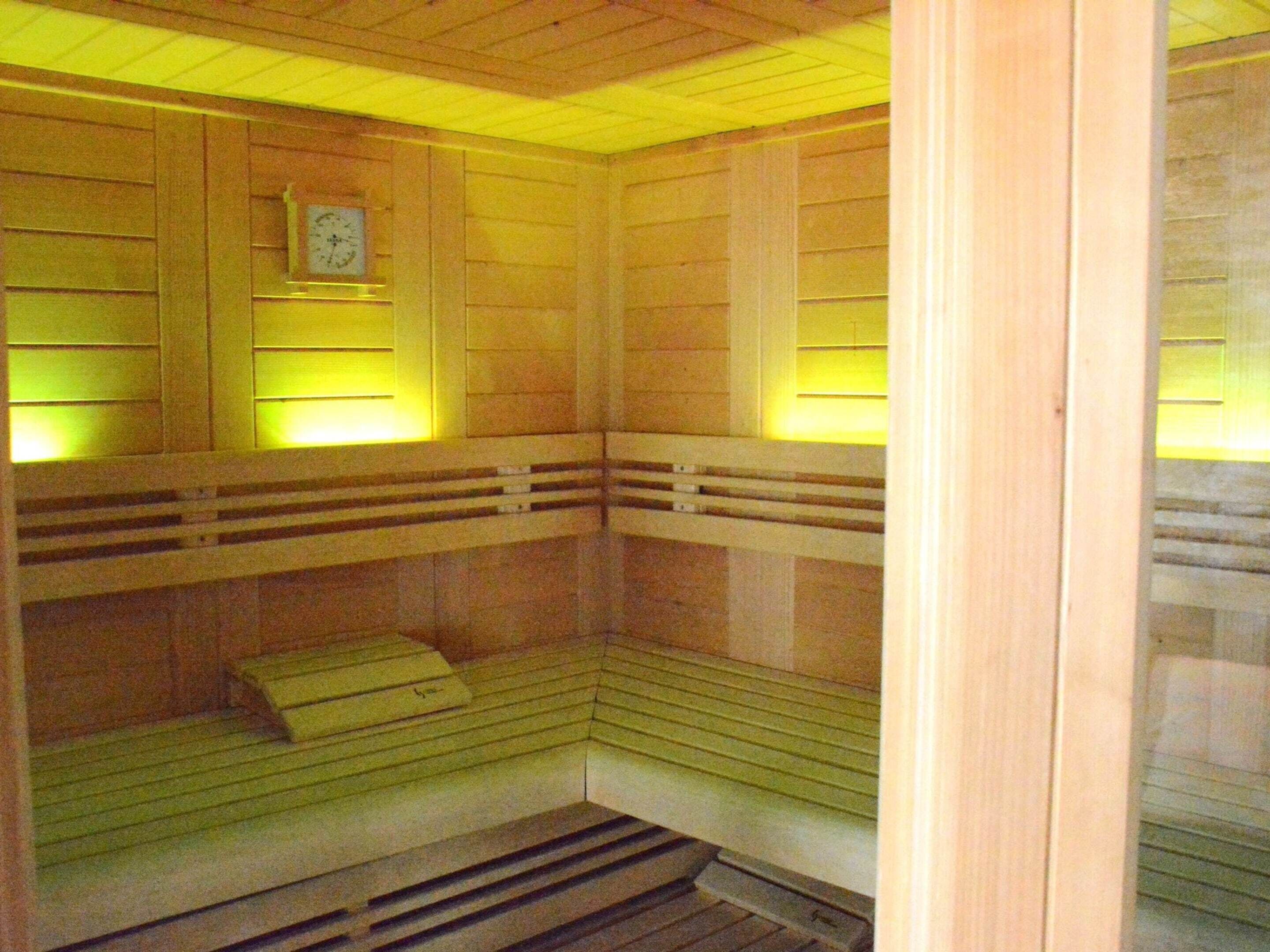 A sauna with wooden benches and slatted walls.