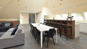A modern loft-style living space with a dining area, a sofa, and a kitchen. - Lovely Holiday Home 'walleken' With a Pond (Aalst)