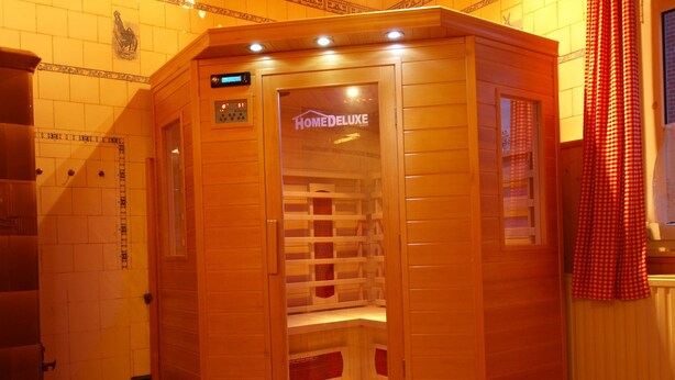 A wooden sauna with a digital control panel, a glass door, and a red checkered curtain. - Heritage Villa With Home Cinema, Sauna (Treuen)