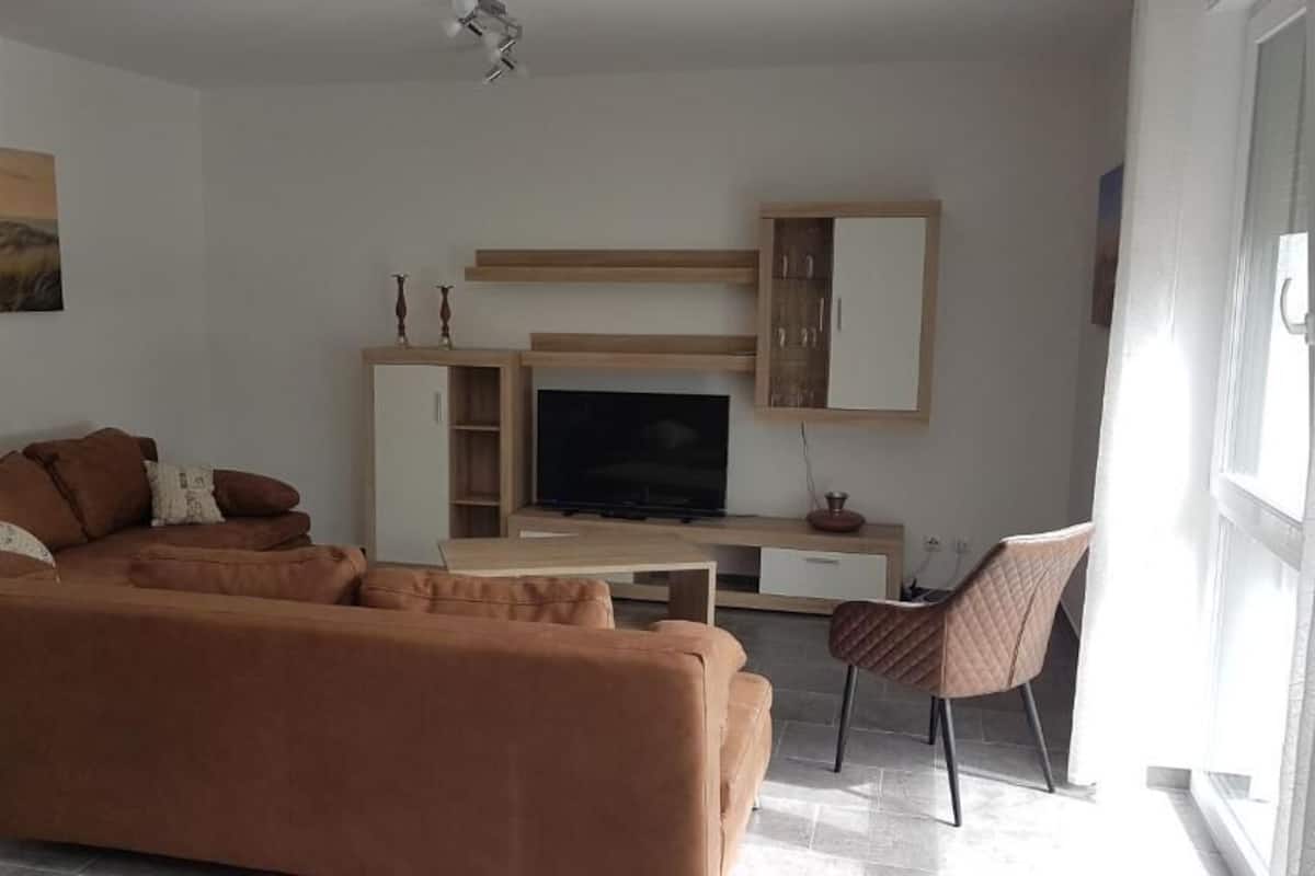 Deluxe Apartment | Living room | 108-cm flat-screen TV with satellite channels, TV, heated floors