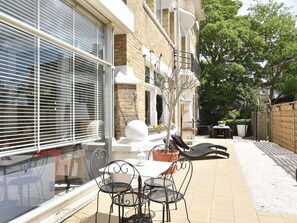 Relax in an outdoor space with a seating area, table, and decorative accents.