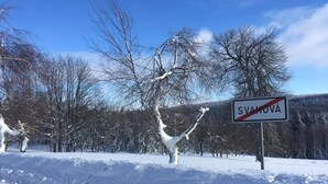 A snowy landscape with a sign reading "SVAHOVA" and leafless trees. - House in Bohemian Near Ski Slope (Blatno)