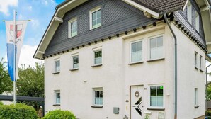 A two-story building with a white exterior and dark roof. - Apartment in Medebach Near Orketal Reserve (Medebach)