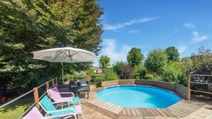 A backyard with a wooden deck, a swimming pool, and lounge chairs. - Pretty House in the Ardennes With Swimming Pool & Games Room (Waimes)