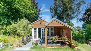 A small wooden house with a patio area, a covered seating area, and a garden with potted plants. - Pretty House in the Ardennes With Swimming Pool & Games Room (Waimes)