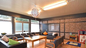 A modern living room with a sofa, chairs, a coffee table, and a fireplace.