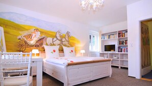 A bedroom with a bed, a desk, a chair, a bookshelf, and a mural on the wall. - Spacious Villa near Forest in Buchet (Lam)