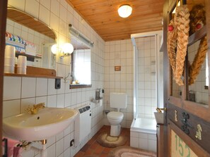 A bathroom with a sink, toilet, and shower.
