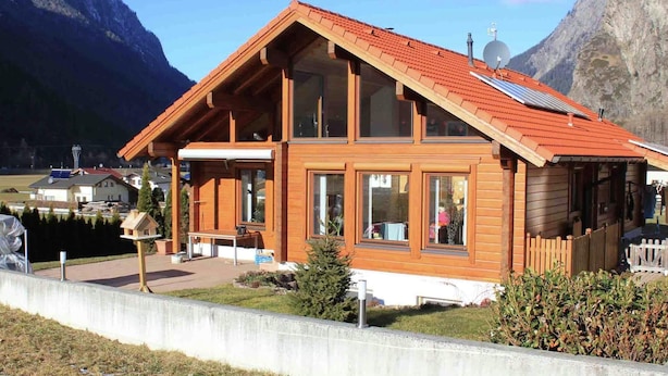 A wooden chalet with a sloped roof, large windows, and a solar panel. - Quaint Apartment in Umhausen near Ski Area (Umhausen)
