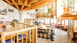 A restaurant with wooden beams, tiled floors, and a variety of seating including tables and stools. - Apartment in Langenfeld Near Solden Ski Lift (Laengenfeld)