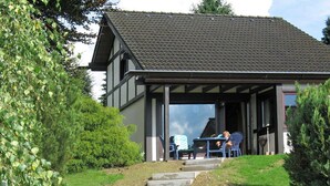 A two-story building with a covered patio area. - Holiday Home in Mielinghausen Near ski Area (Meschede)